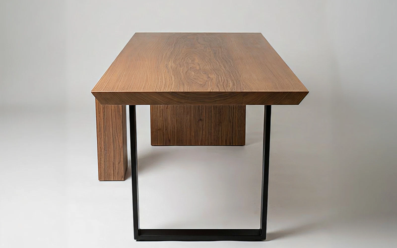 Front view of a minimalist Wood Capitol teak table Front view of a minimalist Wood Capitol teak table.
